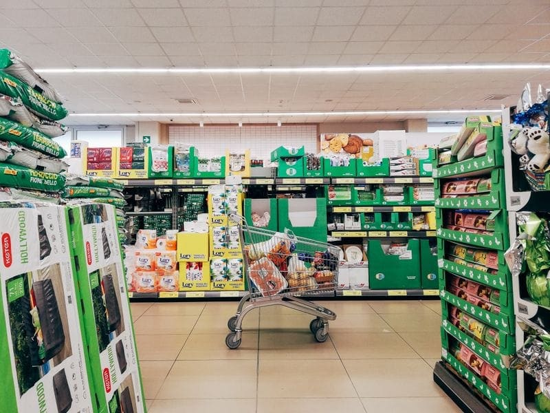 Well-stocked grocery shelves with household essentials and packaged foods