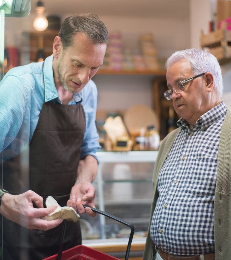 Shopkeeper at Shree Maa Stores helping a customer with product selection